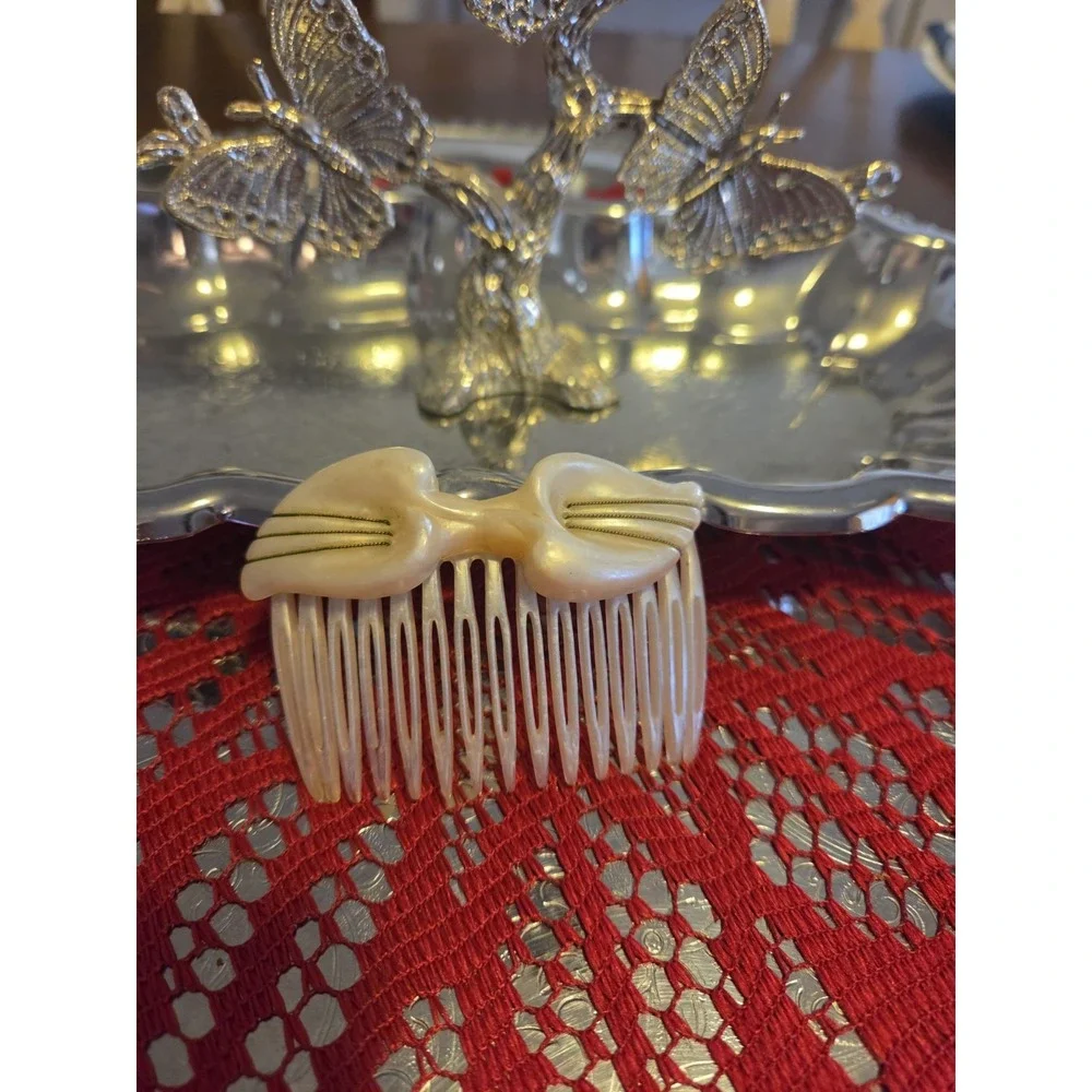 T.Z. Inc. 1981 vintage hair comb is made of faux mother-of-pearl cellulose...